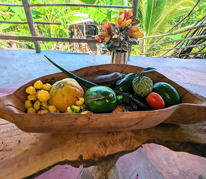 An ever changing array of fresh tropical produce in a hand-carved bowl & table made from guango