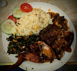 Jerk chicken with barbecue sauce, pumpkin rice, callaloo, & other veg